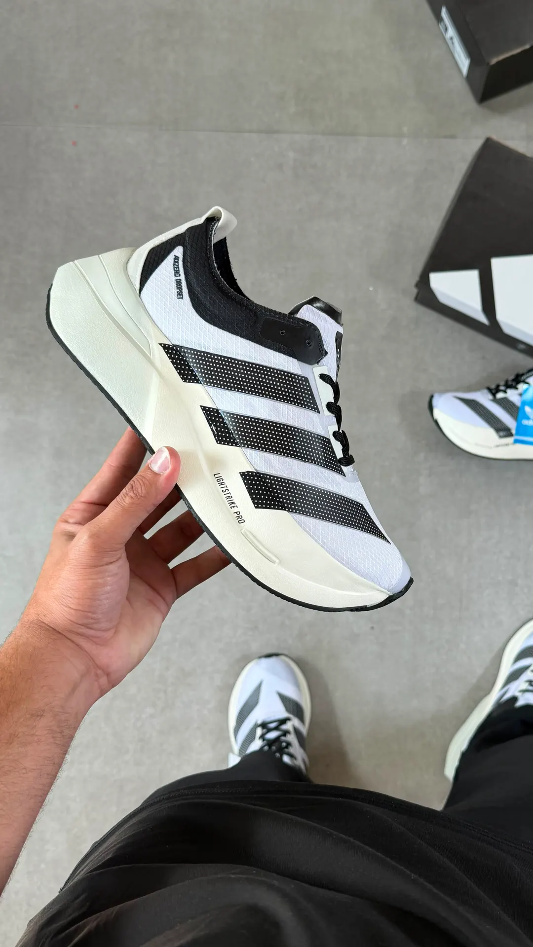 Tênis de treino branco com listras pretas e entressola off-white